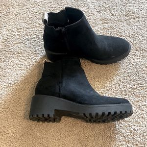 Black booties with snakeskin tag